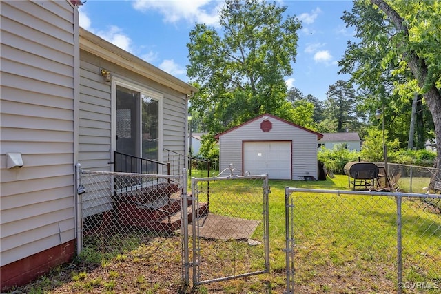 1007 Bolton Rd, Richmond, VA 23225 - view of yard featuring a detached garage, a gate, an outdoor structure, and driveway