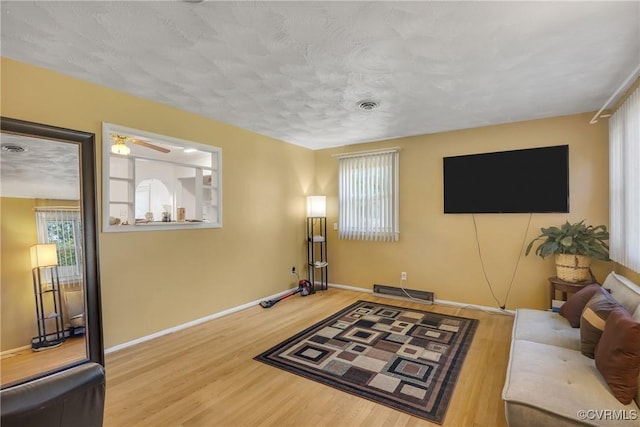 1007 Bolton Rd, Richmond, VA 23225 - living area featuring wood finished floors, a ceiling fan, and a textured ceiling