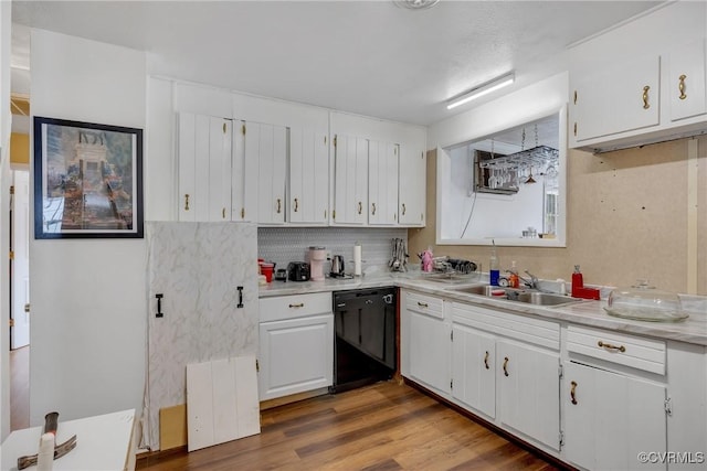 1007 Bolton Rd, Richmond, VA 23225 - kitchen with black dishwasher, white cabinetry, light countertops, wood finished floors, and backsplash