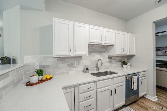11405 Friars Walk Ct, Glen Allen, VA 23059 - kitchen with stainless steel dishwasher, white cabinets, light countertops, tasteful backsplash, and light wood-style floors