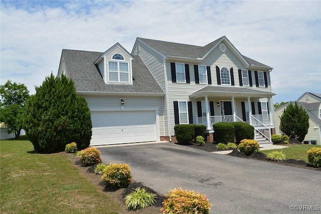 2949 Lookout Ln, Prince George, VA 23860 - colonial home featuring covered porch, asphalt driveway, an attached garage, a shingled roof, and a front lawn