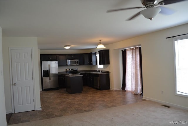 2949 Lookout Ln, Prince George, VA 23860 - kitchen with appliances with stainless steel finishes, a ceiling fan, dark countertops, a center island, and pendant lighting