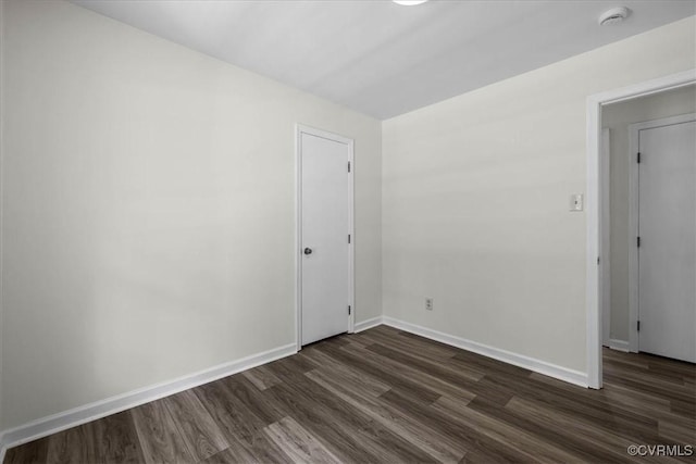 1915 Bogese Dr, Petersburg, VA 23805 - empty room with a smoke detector and dark wood-style floors