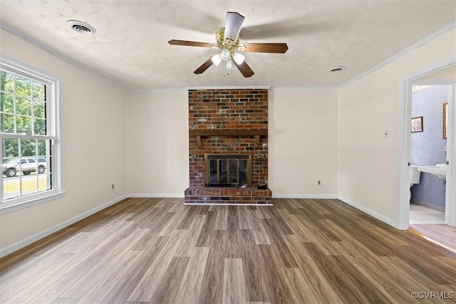 1915 Bogese Dr, Petersburg, VA 23805 - unfurnished living room with wood finished floors, a ceiling fan, a fireplace, and crown molding