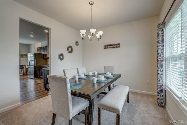 6989 Sir Galahad Rd, Henrico, VA 23231 - dining room featuring light carpet and a chandelier