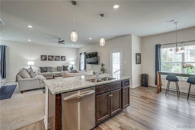 6989 Sir Galahad Rd, Henrico, VA 23231 - kitchen featuring stainless steel dishwasher, dark brown cabinetry, recessed lighting, light stone counters, and hanging light fixtures
