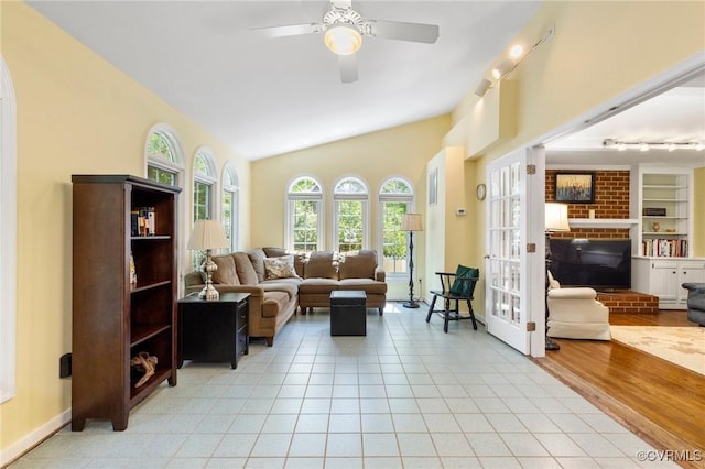 4018 Timber Ridge Rd, Chesterfield, VA 23112 - living area featuring track lighting, ceiling fan, lofted ceiling, a brick fireplace, and light tile patterned floors