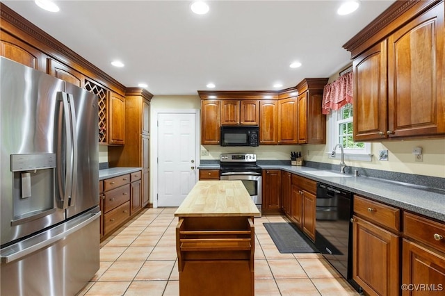 4018 Timber Ridge Rd, Chesterfield, VA 23112 - kitchen featuring black appliances, butcher block counters, light tile patterned floors, recessed lighting, and brown cabinets