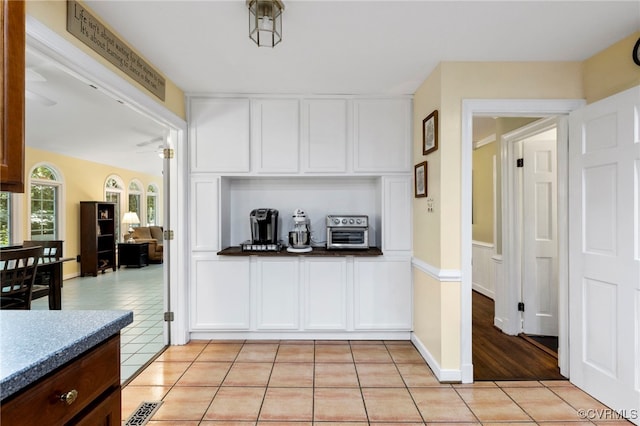 4018 Timber Ridge Rd, Chesterfield, VA 23112 - kitchen with white cabinets, light tile patterned floors, ceiling fan, and dark countertops