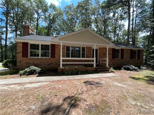 15609 Rowlett Rd, Chesterfield, VA 23838 - ranch-style house featuring brick siding, a chimney, and covered porch