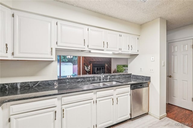 12302 Sir James Ct, Henrico, VA 23233 - kitchen with stainless steel dishwasher, white cabinetry, light wood-style floors, dark stone countertops, and a textured ceiling