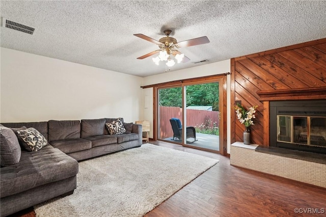 12302 Sir James Ct, Henrico, VA 23233 - living area with wood finished floors, a glass covered fireplace, ceiling fan, and a textured ceiling