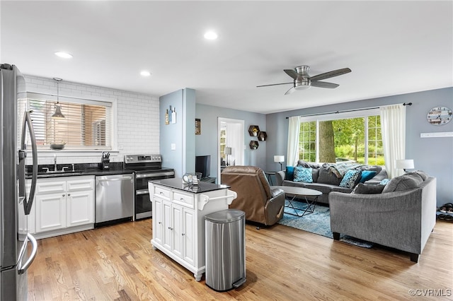 8314 Erma Ln, Richmond, VA 23229 - kitchen with appliances with stainless steel finishes, open floor plan, dark countertops, white cabinets, and light wood finished floors