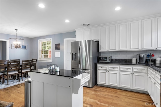 8314 Erma Ln, Richmond, VA 23229 - kitchen featuring stainless steel fridge with ice dispenser, dark countertops, white cabinetry, a chandelier, and recessed lighting