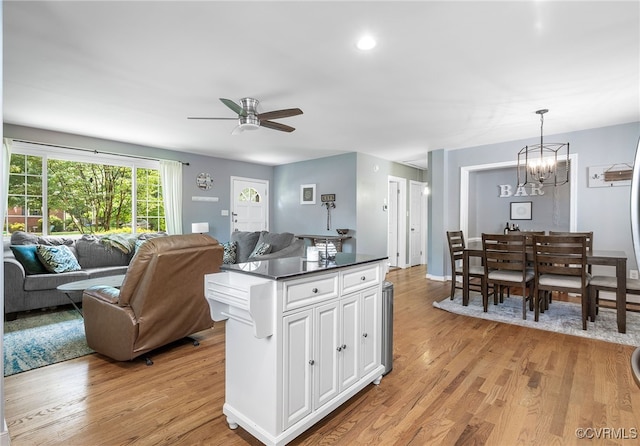8314 Erma Ln, Richmond, VA 23229 - kitchen with ceiling fan, open floor plan, light wood finished floors, dark countertops, and white cabinetry