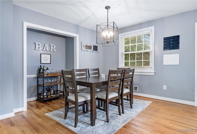 8314 Erma Ln, Richmond, VA 23229 - dining space featuring wood finished floors and a chandelier