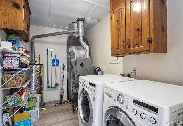 8314 Erma Ln, Richmond, VA 23229 - laundry room with cabinet space, light wood-style floors, washing machine and dryer, and water heater