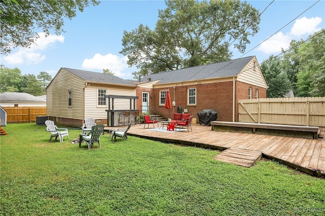 8314 Erma Ln, Richmond, VA 23229 - rear view of house featuring a fenced backyard, a deck, and an outdoor fire pit