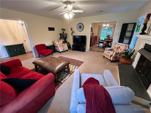 2205 Cox Rd, Henrico, VA 23233 - living room with a chandelier, ceiling fan, a fireplace, and carpet
