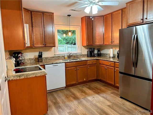 2205 Cox Rd, Henrico, VA 23233 - kitchen featuring freestanding refrigerator, white dishwasher, and brown cabinetry