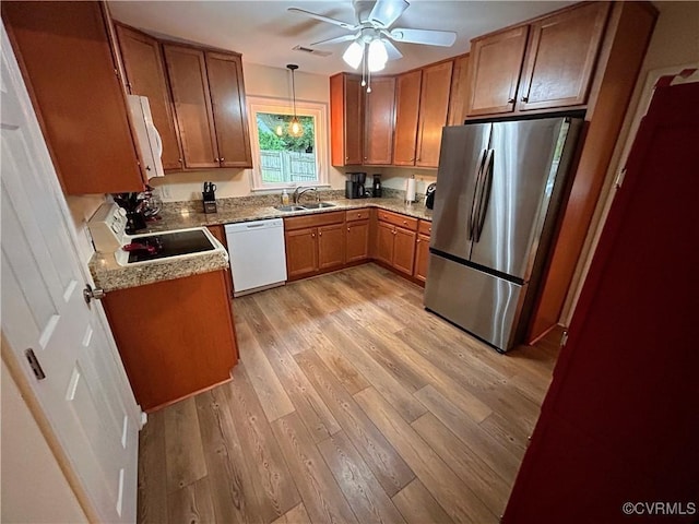 2205 Cox Rd, Henrico, VA 23233 - kitchen featuring white appliances, brown cabinets, a ceiling fan, light wood finished floors, and pendant lighting