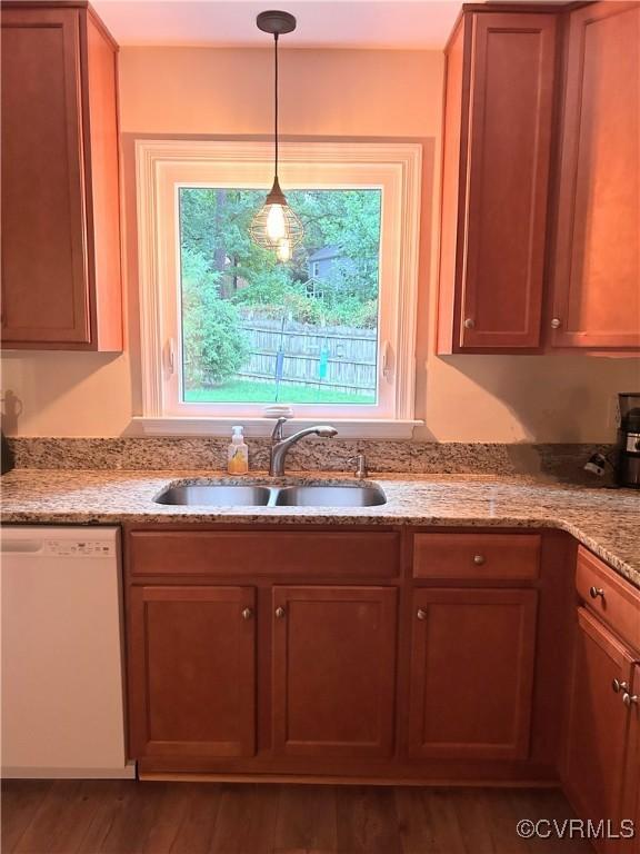 2205 Cox Rd, Henrico, VA 23233 - kitchen with white dishwasher, wood finished floors, light stone counters, hanging light fixtures, and brown cabinets