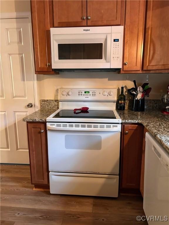 2205 Cox Rd, Henrico, VA 23233 - kitchen with white appliances, brown cabinetry, wood finished floors, and dark stone counters
