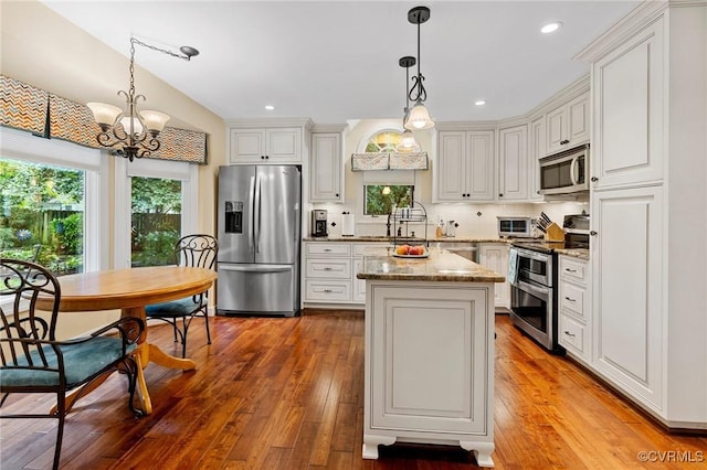 4723 Squaw Valley Ct, Glen Allen, VA 23060 - kitchen featuring stainless steel appliances, a chandelier, a kitchen island, light wood-style floors, and light stone counters