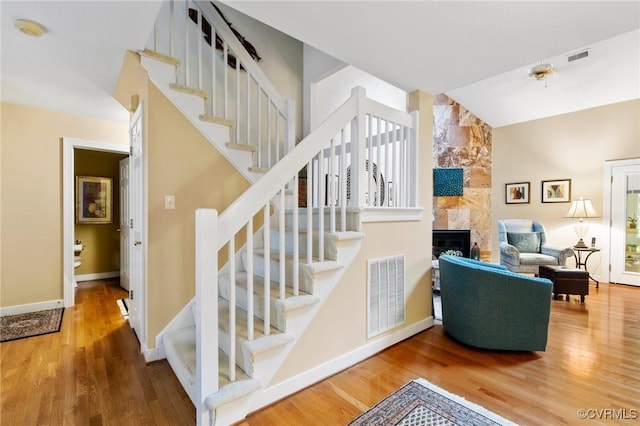4723 Squaw Valley Ct, Glen Allen, VA 23060 - stairway featuring a tile fireplace, wood finished floors, and vaulted ceiling