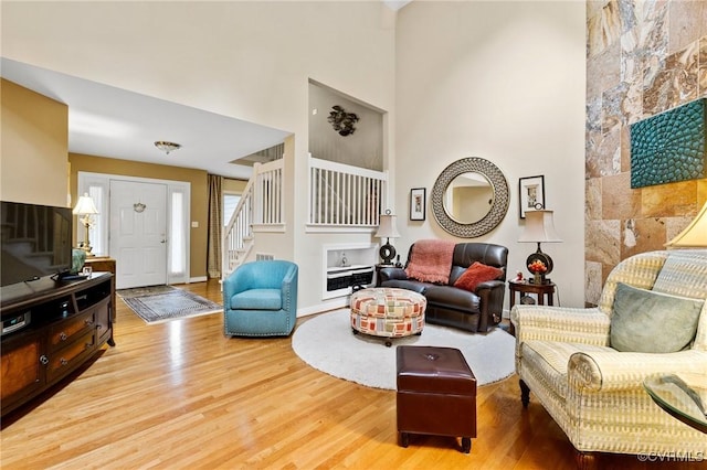 4723 Squaw Valley Ct, Glen Allen, VA 23060 - living room featuring stairs, wood finished floors, and a towering ceiling