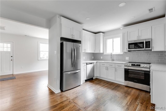 1409 Virginia Ave, Glen Allen, VA 23060 - kitchen with appliances with stainless steel finishes, light countertops, decorative backsplash, healthy amount of natural light, and recessed lighting