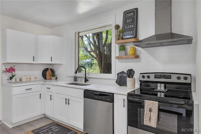 8912 Michaux Ln, Henrico, VA 23229 - kitchen with stainless steel appliances, wall chimney exhaust hood, backsplash, white cabinetry, and light countertops