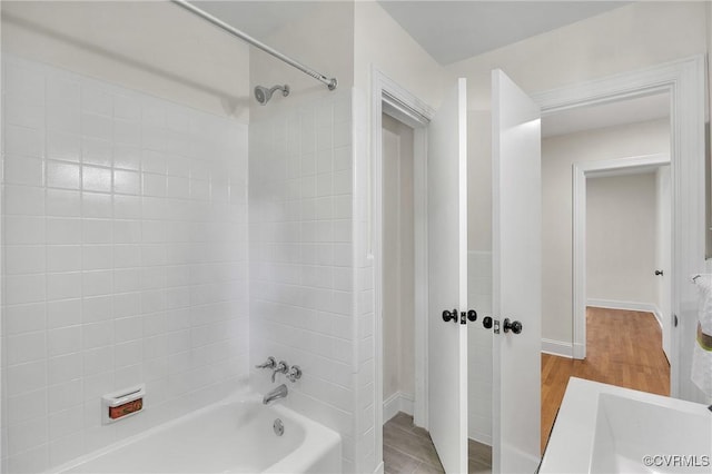 8912 Michaux Ln, Henrico, VA 23229 - bathroom featuring shower / bathtub combination and wood finished floors