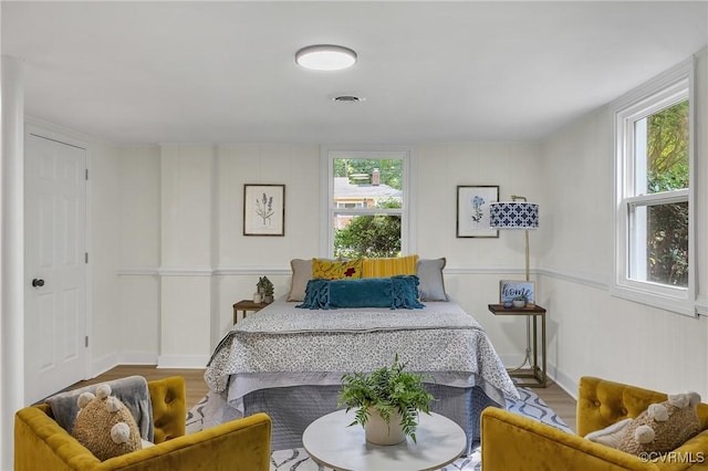 8912 Michaux Ln, Henrico, VA 23229 - bedroom featuring multiple windows and wood finished floors