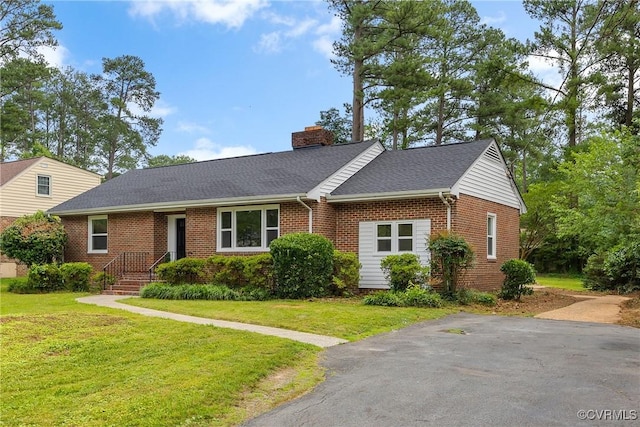 7709 Yolanda Rd, Henrico, VA 23229 - view of front of house with brick siding, a chimney, a front yard, and a shingled roof
