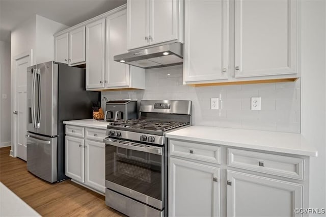 7653 Autumn Leaves Ln, New Kent, VA 23124 - kitchen featuring stainless steel appliances, under cabinet range hood, light wood-style floors, and white cabinetry