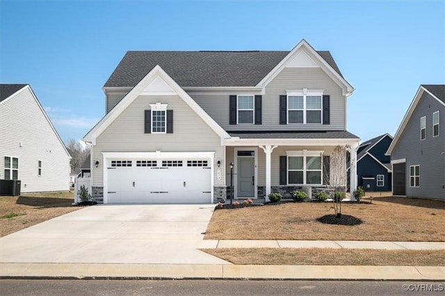 7653 Autumn Leaves Ln, New Kent, VA 23124 - view of front of property featuring concrete driveway, covered porch, an attached garage, and stone siding