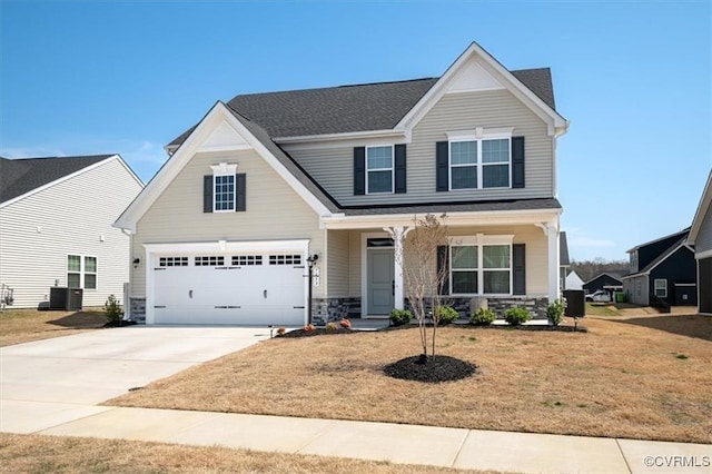 7653 Autumn Leaves Ln, New Kent, VA 23124 - craftsman-style house with stone siding, driveway, an attached garage, and a front yard