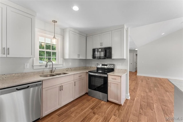 699 Trimmers Shop Rd, King William, VA 23181 - kitchen with appliances with stainless steel finishes, light wood-style flooring, light stone countertops, pendant lighting, and recessed lighting