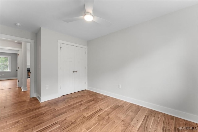 699 Trimmers Shop Rd, King William, VA 23181 - unfurnished bedroom featuring light wood-style flooring, a closet, and a ceiling fan
