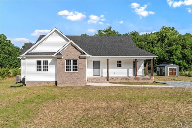 699 Trimmers Shop Rd, King William, VA 23181 - view of front of house with a storage shed, covered porch, a front yard, and roof with shingles
