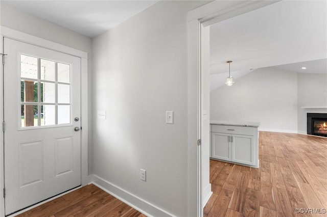 699 Trimmers Shop Rd, King William, VA 23181 - doorway to outside with light wood-style flooring, a warm lit fireplace, and lofted ceiling
