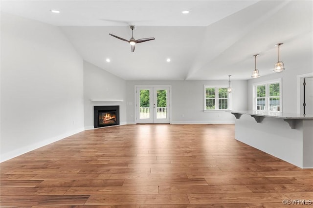 699 Trimmers Shop Rd, King William, VA 23181 - unfurnished living room featuring lofted ceiling, wood-type flooring, a warm lit fireplace, ceiling fan, and recessed lighting