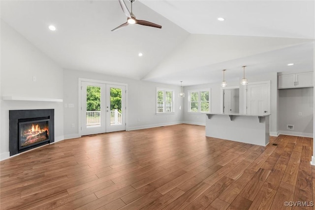 699 Trimmers Shop Rd, King William, VA 23181 - unfurnished living room featuring vaulted ceiling, a ceiling fan, wood finished floors, a glass covered fireplace, and recessed lighting