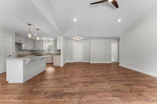 699 Trimmers Shop Rd, King William, VA 23181 - kitchen featuring a center island, vaulted ceiling, a ceiling fan, open floor plan, and light wood-type flooring