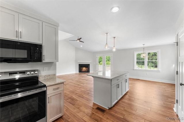 699 Trimmers Shop Rd, King William, VA 23181 - kitchen featuring electric stove, black microwave, a warm lit fireplace, a ceiling fan, and light stone countertops