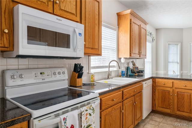 14313 Woodleigh Dr, Chester, VA 23831 - kitchen featuring white appliances, brown cabinetry, tasteful backsplash, dark countertops, and a textured ceiling