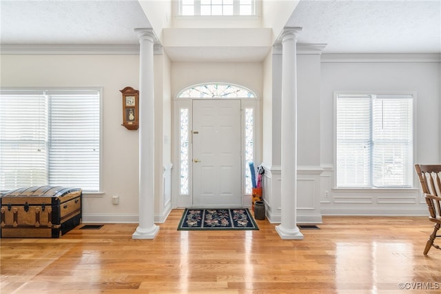 14313 Woodleigh Dr, Chester, VA 23831 - entryway with ornate columns, wood finished floors, crown molding, and wainscoting