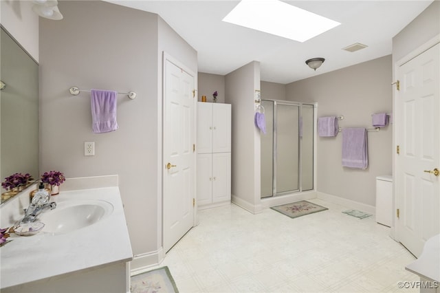 14313 Woodleigh Dr, Chester, VA 23831 - bathroom with vanity, a shower stall, tile patterned floors, a skylight, and a closet