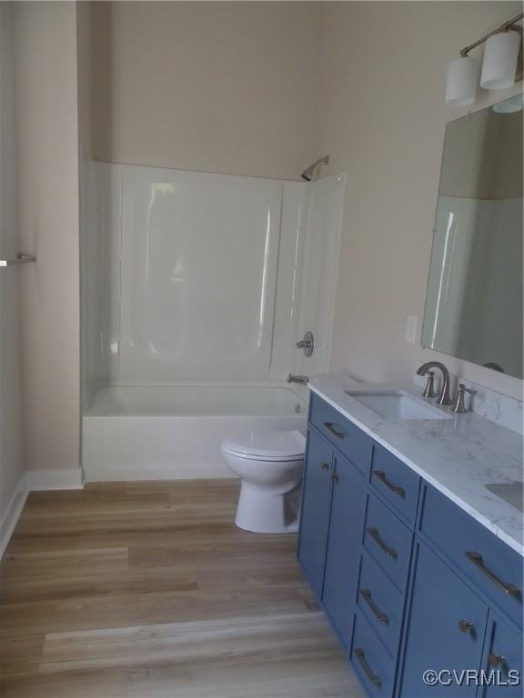 1120 Halifax St, Petersburg, VA 23803 - bathroom with double vanity, shower / washtub combination, and wood finished floors